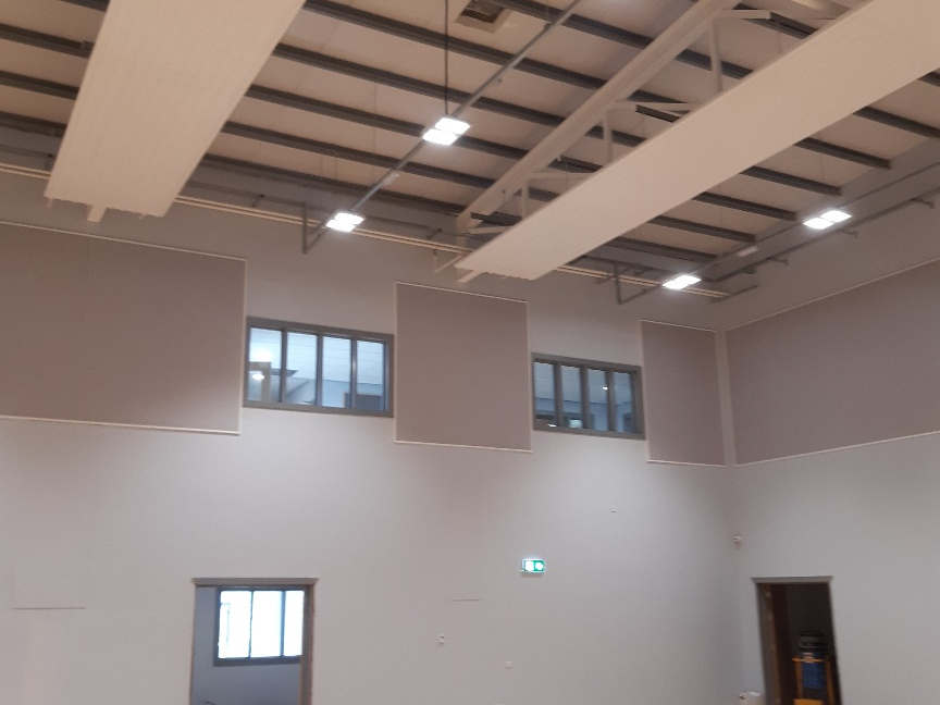 Sound absorbing acoustic panels in community centre hall.